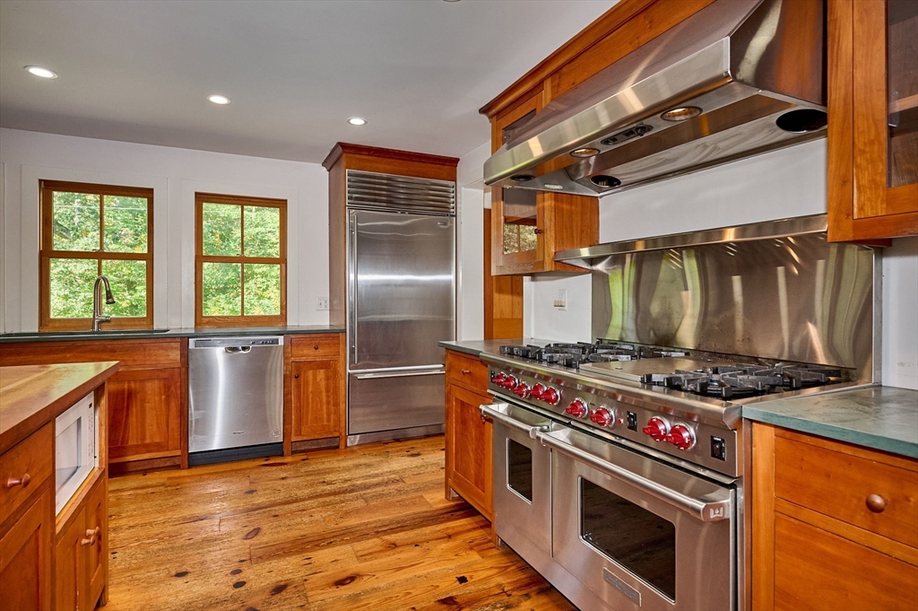 81 Smith Road Ashfield, MA 01330 - Photo 4 of 41 a kitchen with stainless steel appliances granite countertop a stove and a refrigerator