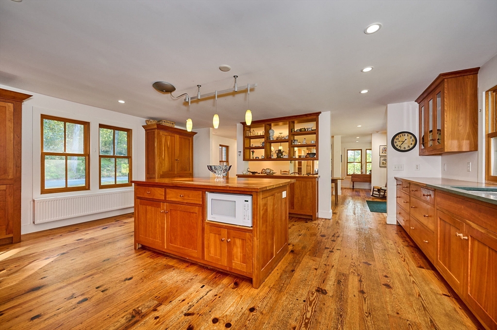 81 Smith Road Ashfield, MA 01330 - Photo 6 of 41 a large kitchen with stainless steel appliances kitchen island a large counter top and a wooden floors