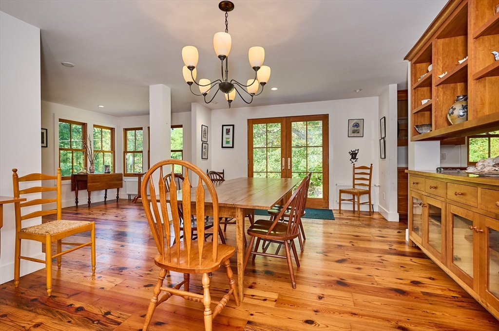 81 Smith Road Ashfield, MA 01330 - Photo 8 of 41 a view of a dining room with furniture a chandelier and wooden floor