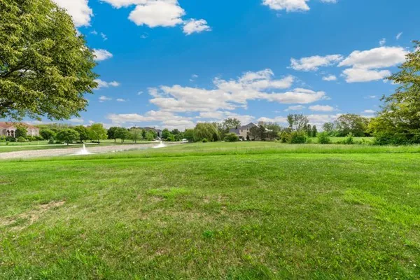 a view of a golf course with a big yard