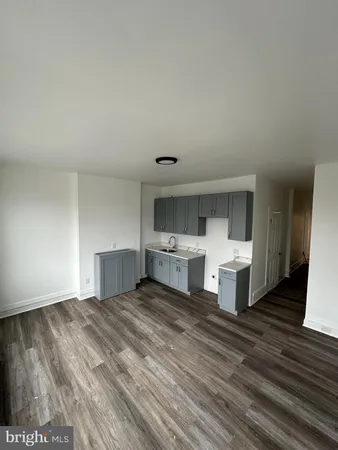 a view of a room with wooden floor and bathroom