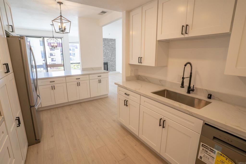 5845 Friars Road, Unit 1316 San Diego, CA 92110 - Photo 11 of 29 a kitchen with white cabinets and sink