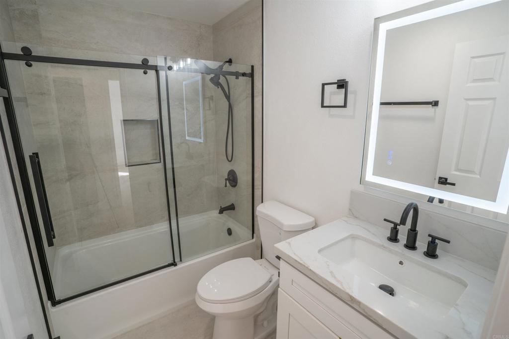 5845 Friars Road, Unit 1316 San Diego, CA 92110 - Photo 17 of 29 a bathroom with a sink toilet and shower