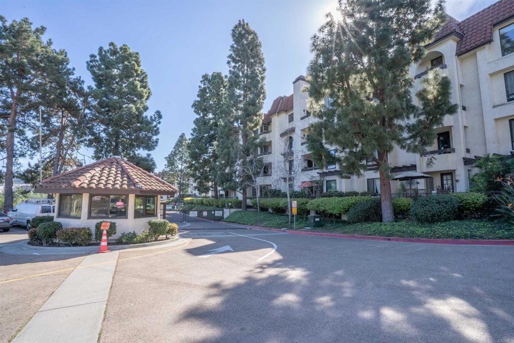 5845 Friars Road, Unit 1316 San Diego, CA 92110 - Photo 3 of 29 a front view of a house with a yard and trees