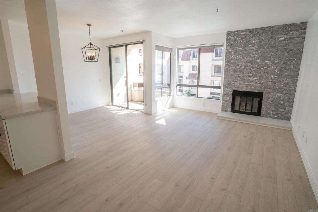 5845 Friars Road, Unit 1316 San Diego, CA 92110 - Photo 5 of 29 wooden floor fireplace and windows in an empty room