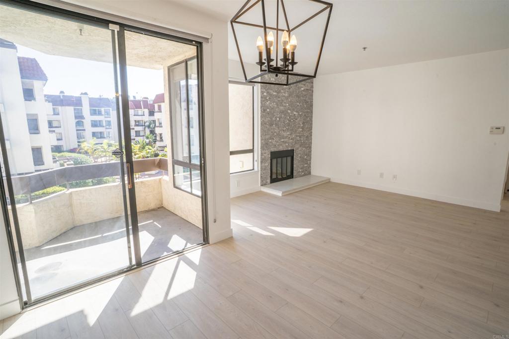 5845 Friars Road, Unit 1316 San Diego, CA 92110 - Photo 6 of 29 a view of empty room with floor to ceiling window and chandelier
