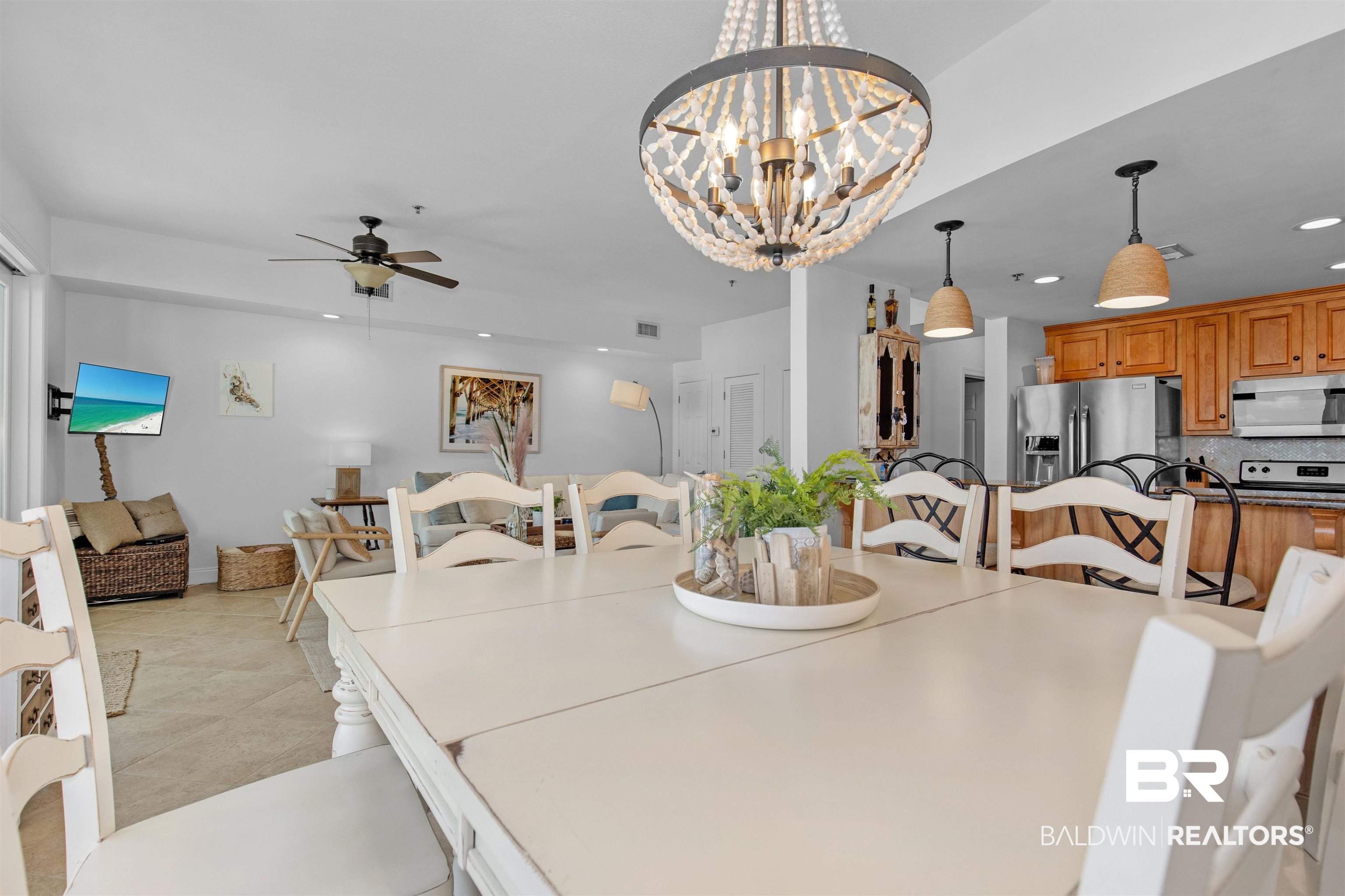 25909 Canal Road, Unit 301 Orange Beach, AL 36561 - Photo 13 of 43 Dining area featuring ceiling fan with notable chandelier