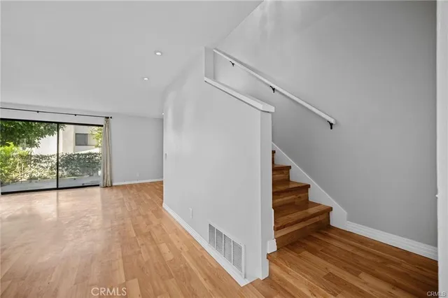 a view of entryway and hall with wooden floor
