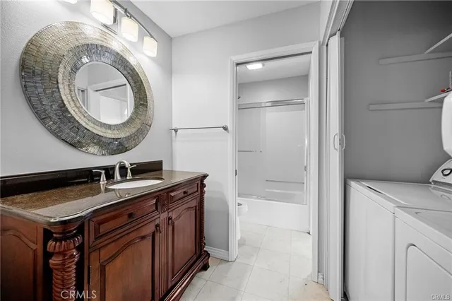 a kitchen with a sink a toilet and a mirror