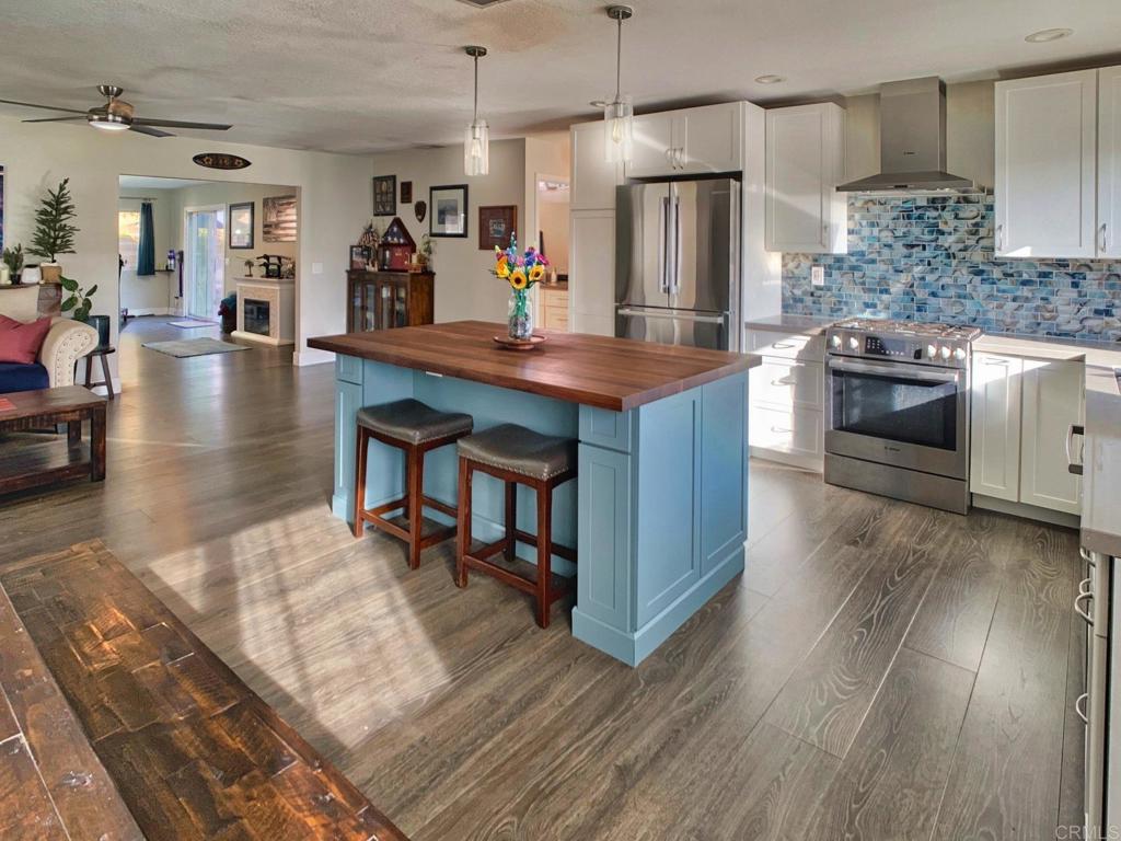 a kitchen with stainless steel appliances granite countertop a stove and refrigerator