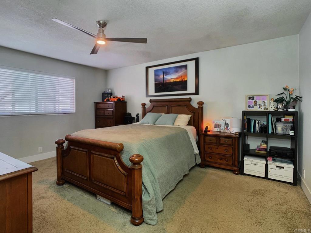13758 Pomerado Road Poway, CA 92064 - Photo 20 of 32 a bedroom with a bed and a flat tv screen