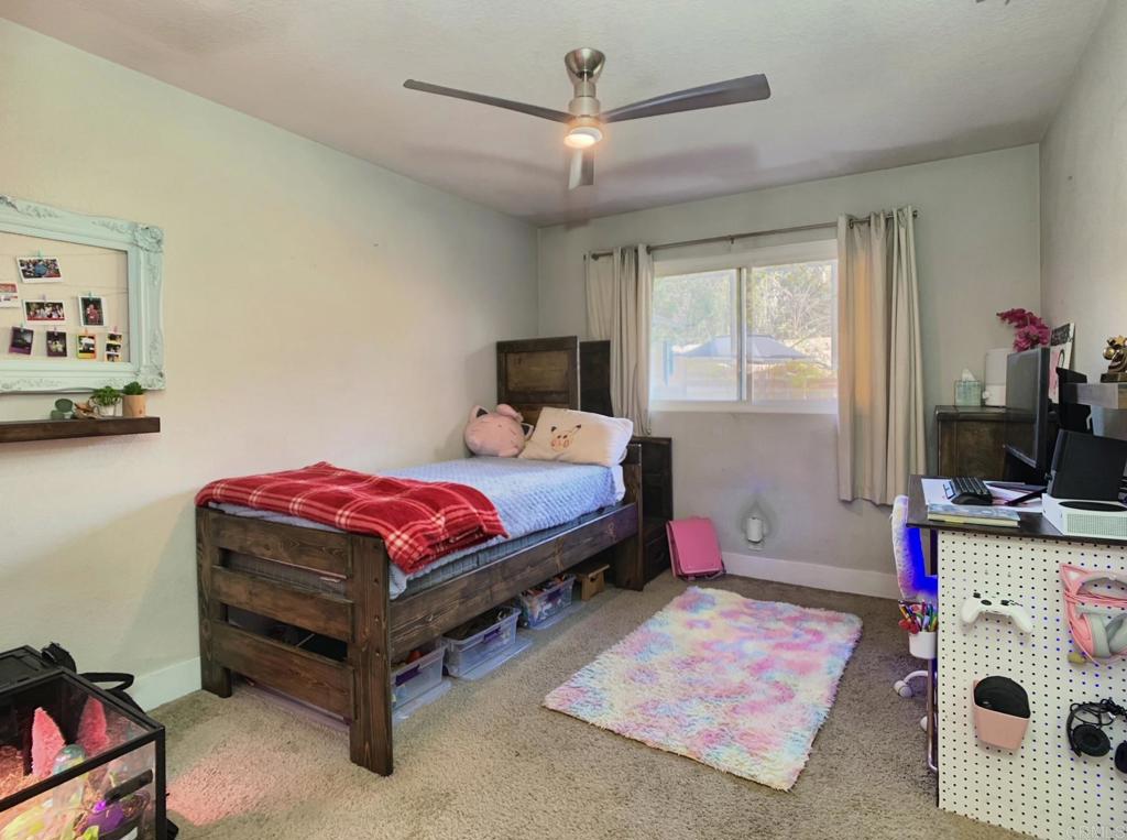 13758 Pomerado Road Poway, CA 92064 - Photo 23 of 32 a bedroom with a bed dresser and a window