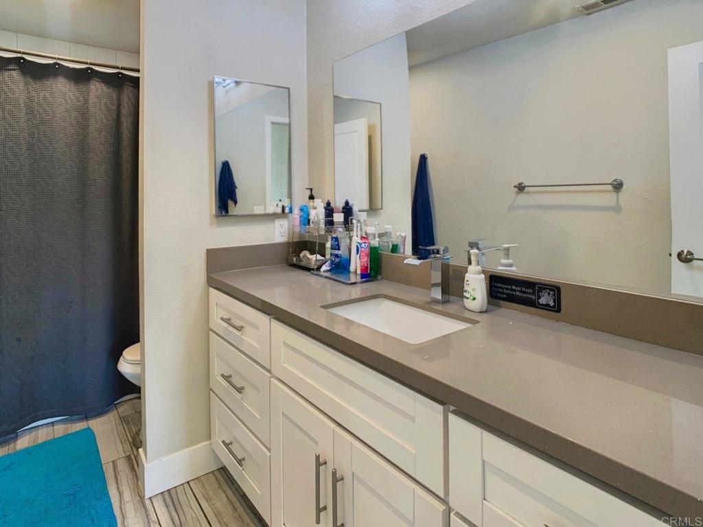 13758 Pomerado Road Poway, CA 92064 - Photo 27 of 32 a bathroom with a sink and a mirror