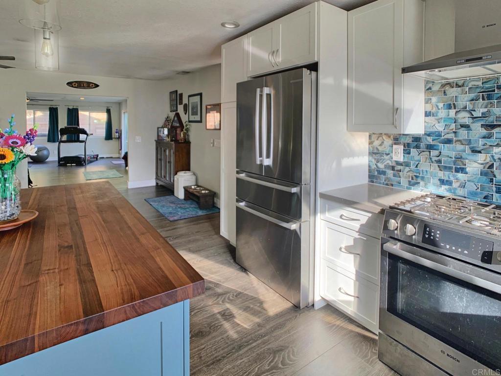 13758 Pomerado Road Poway, CA 92064 - Photo 9 of 32 a kitchen with kitchen island a counter top space a sink stainless steel appliances and cabinets
