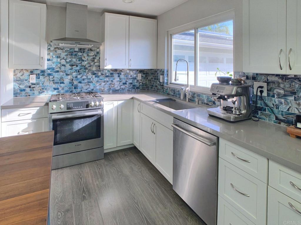 13758 Pomerado Road Poway, CA 92064 - Photo 10 of 32 a kitchen with stainless steel appliances white cabinets a sink and a stove