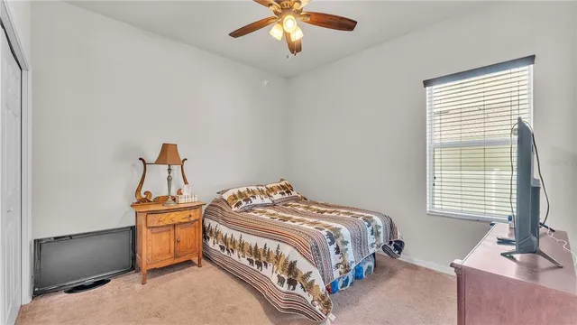 a room with a ceiling fan and a window