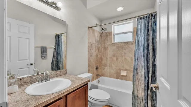 a bathroom with a sink toilet a shower and a mirror