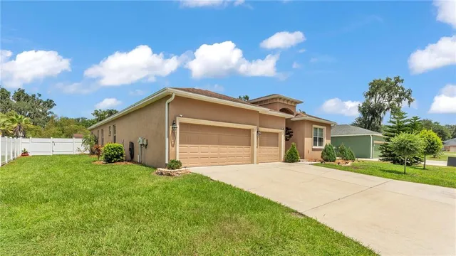 an aerial view of residential houses with outdoor space and street view