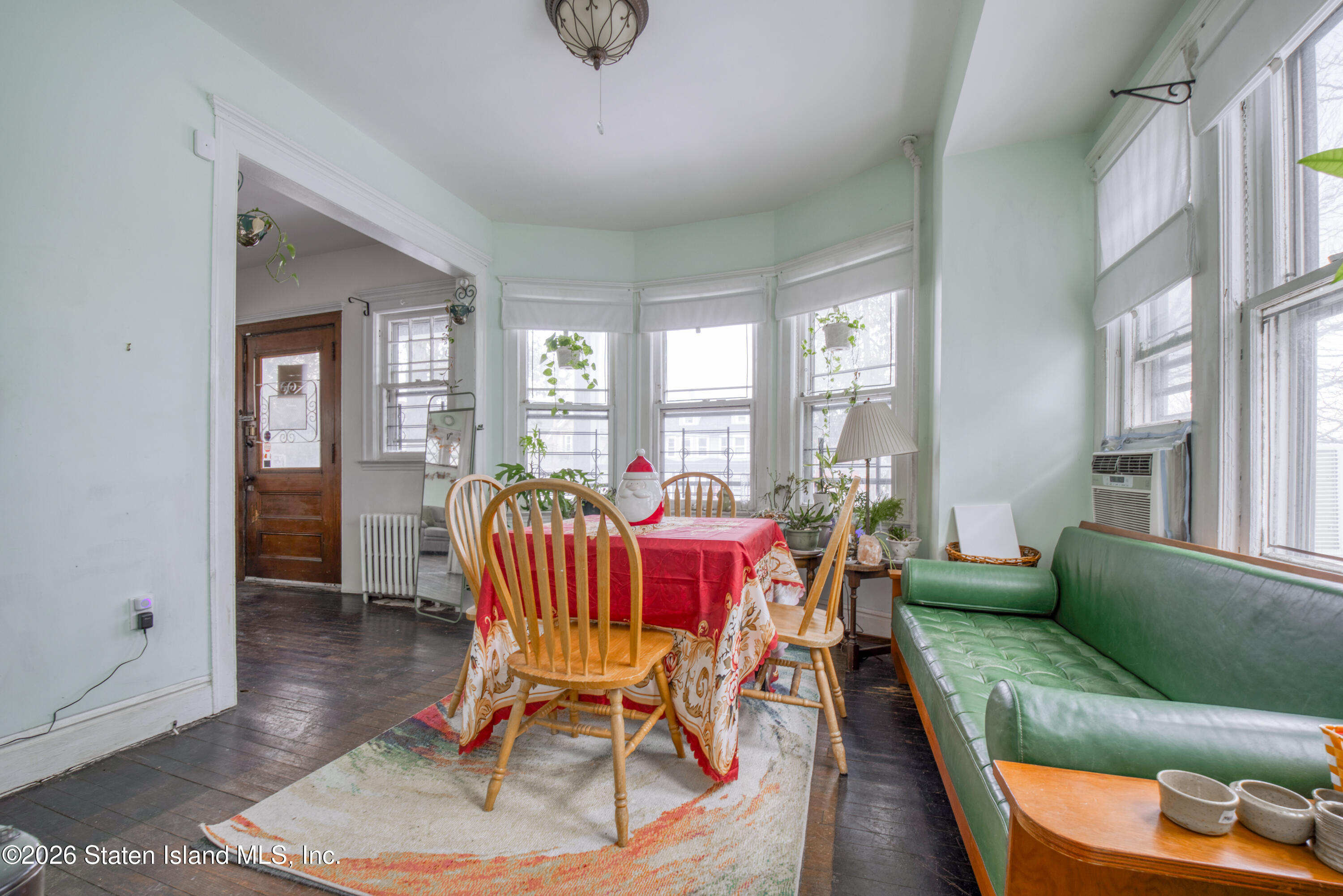 226 Castleton Avenue Staten Island, NY 10301 - Photo 11 of 32 a living room with furniture and a floor to ceiling window