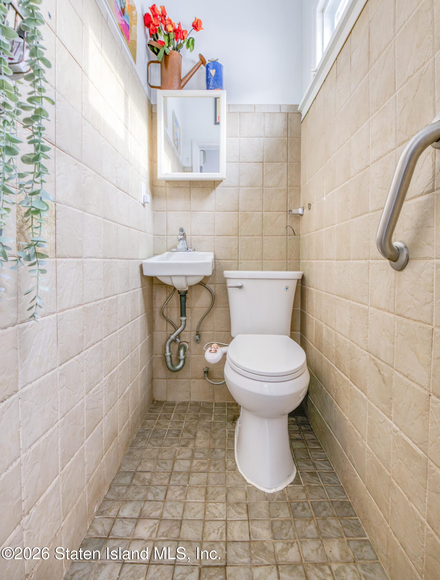 226 Castleton Avenue Staten Island, NY 10301 - Photo 12 of 32 a bathroom with a toilet and a shower