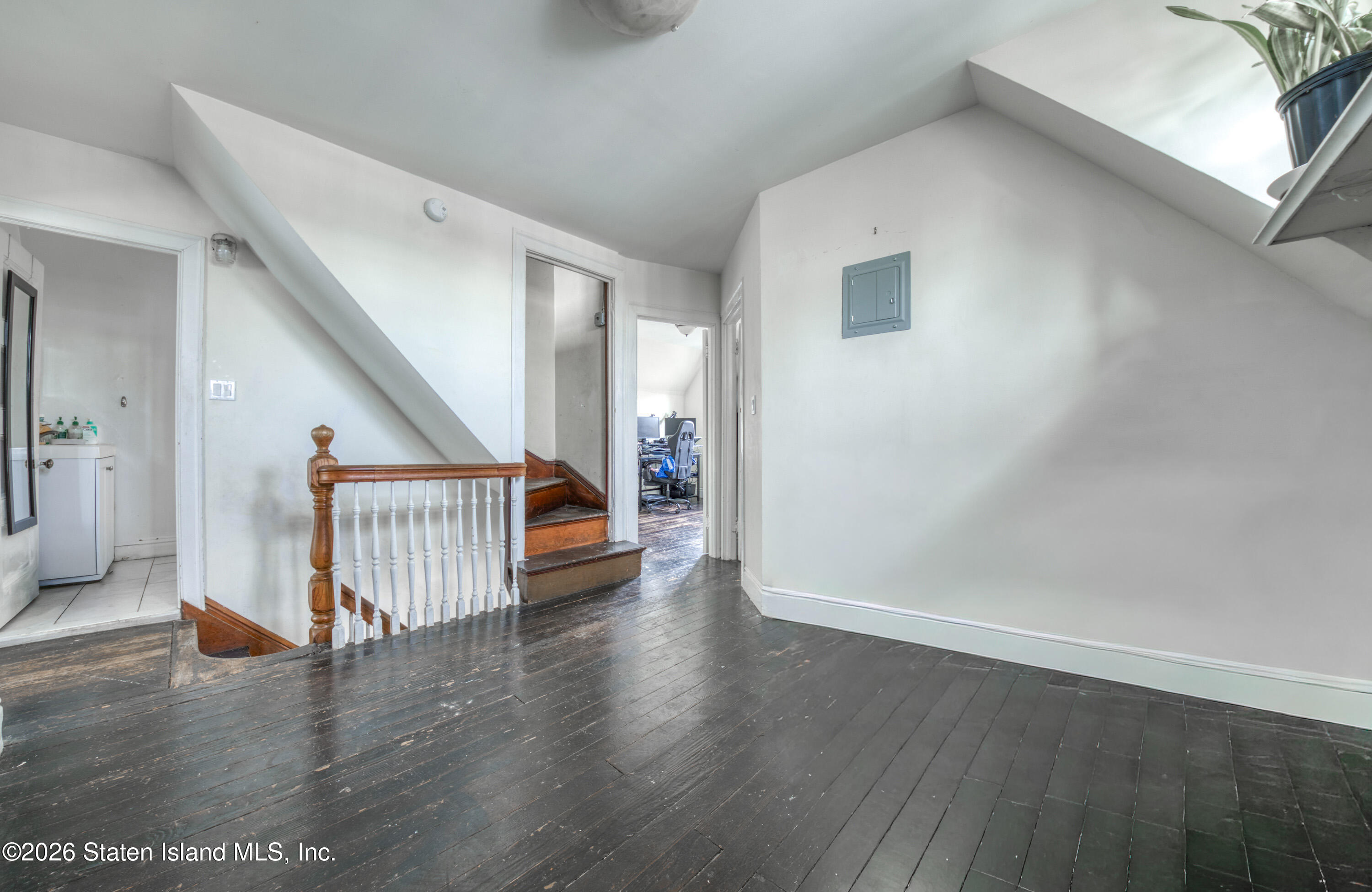 226 Castleton Avenue Staten Island, NY 10301 - Photo 14 of 32 a view of a hallway with wooden floor and stairs