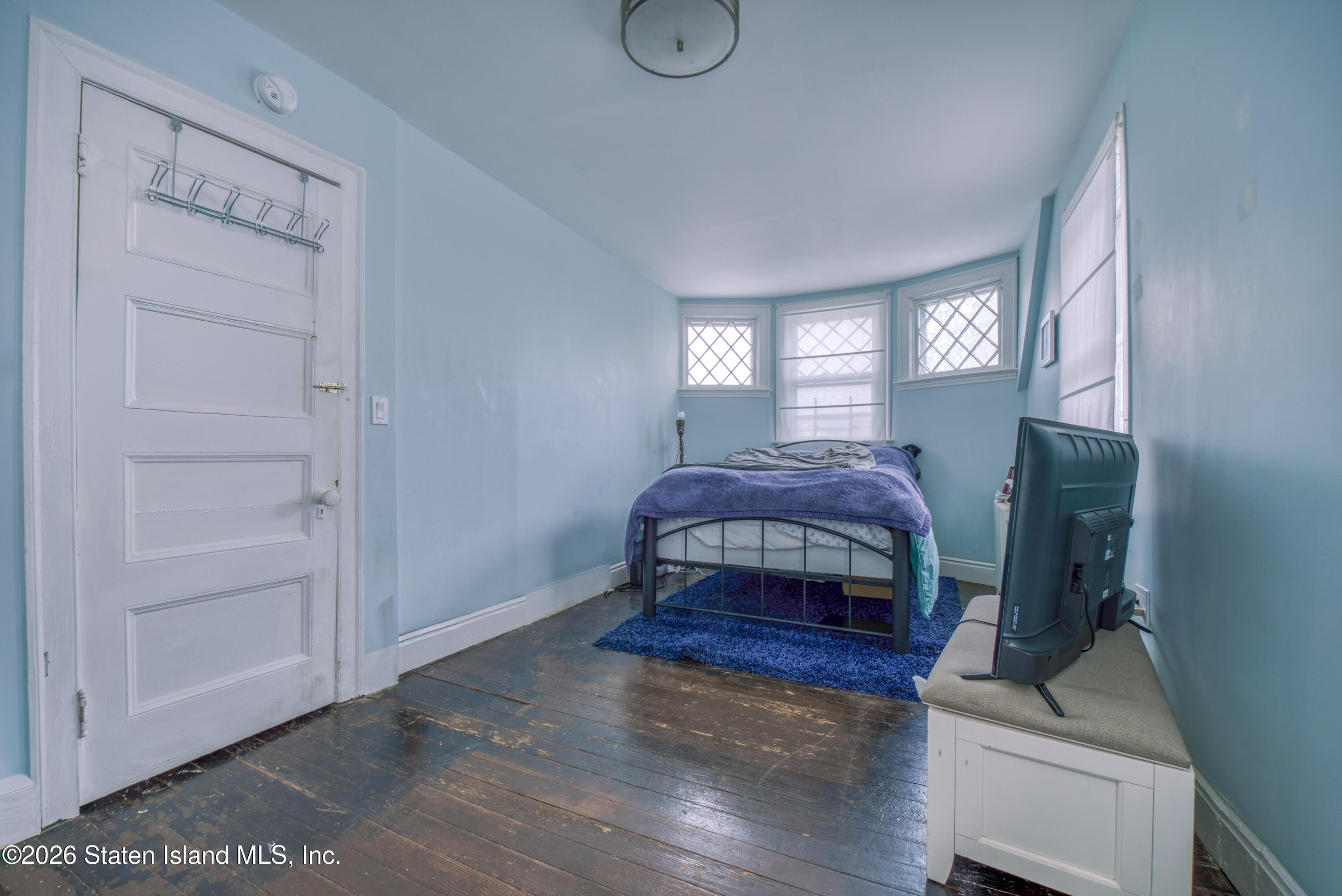 226 Castleton Avenue Staten Island, NY 10301 - Photo 16 of 32 a bedroom with a bed and window