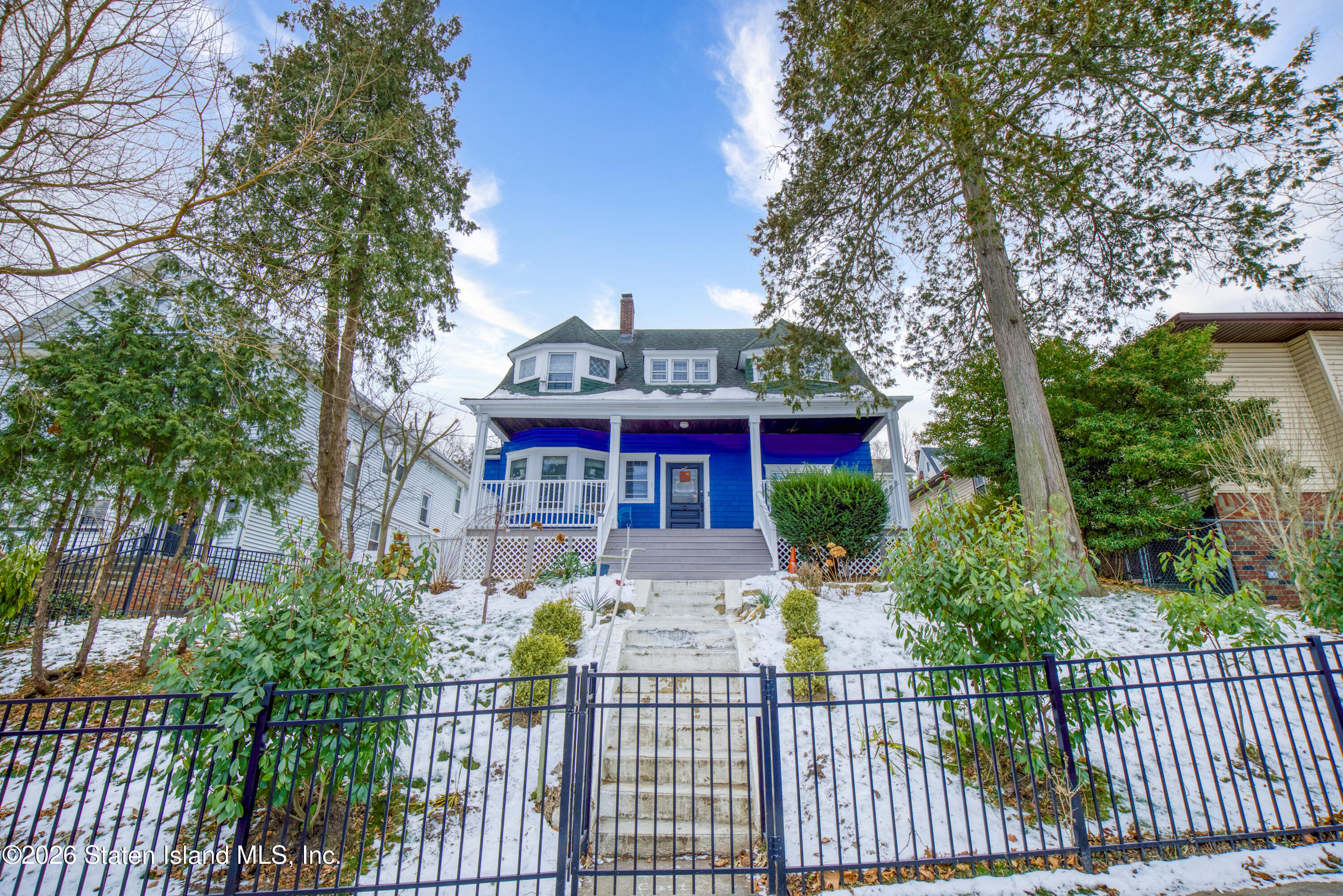 226 Castleton Avenue Staten Island, NY 10301 - Photo 31 of 32 a view of a house with brick walls and flower plants