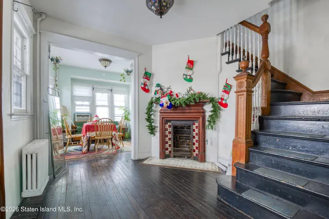 a view of entryway livingroom and hall with wooden floor