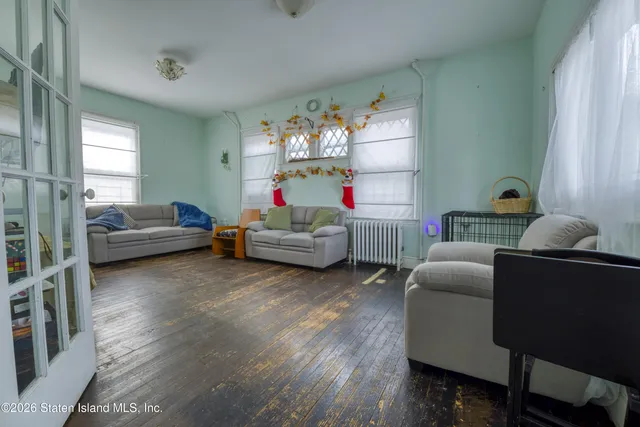 a living room with furniture window and wooden floor