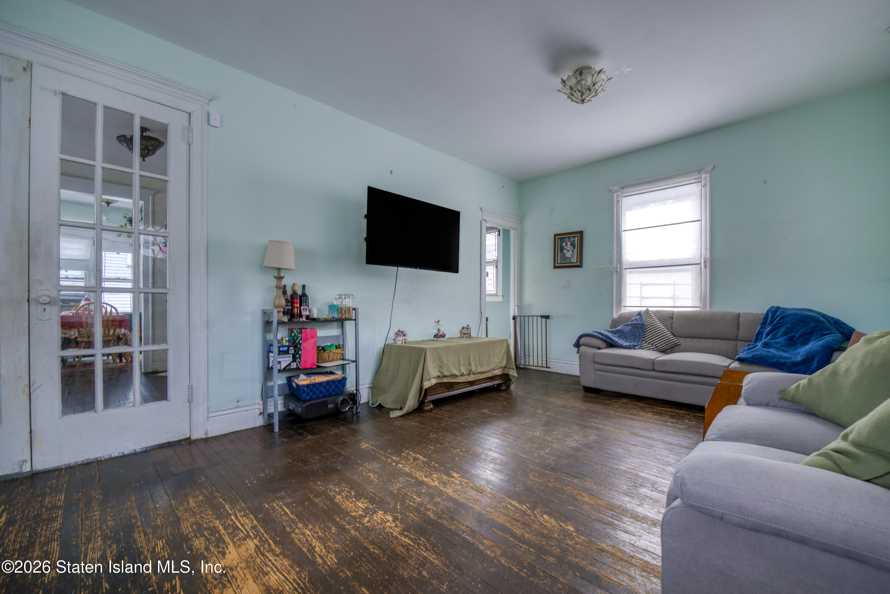 226 Castleton Avenue Staten Island, NY 10301 - Photo 7 of 32 a living room with furniture and a flat screen tv