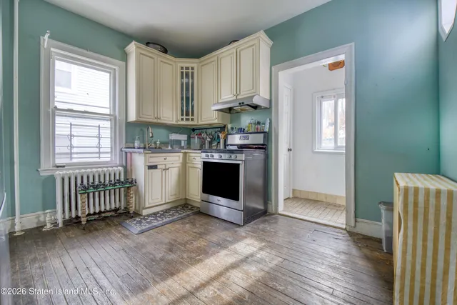 a room with a wooden floor and a window