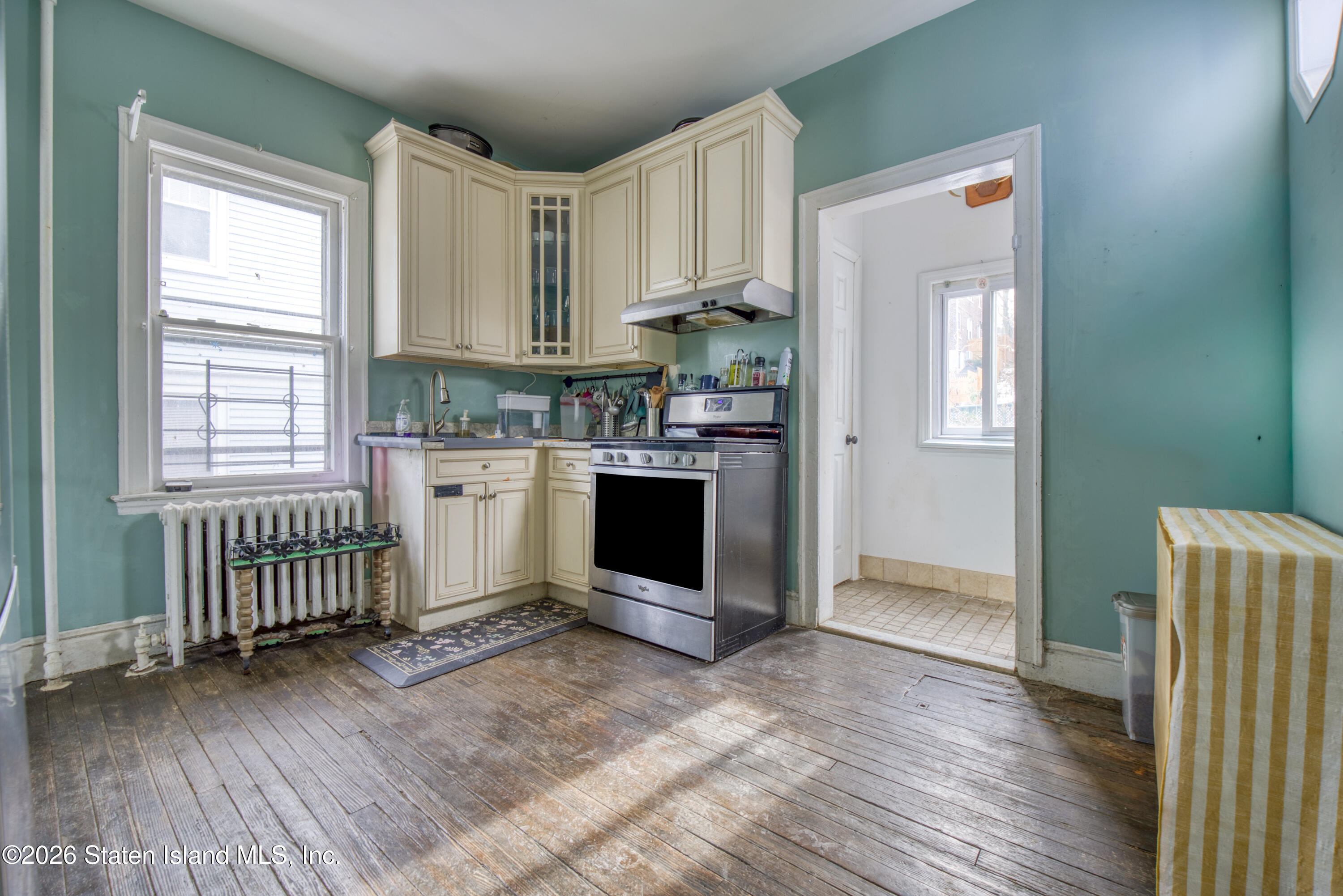 226 Castleton Avenue Staten Island, NY 10301 - Photo 9 of 32 a room with a wooden floor and a window
