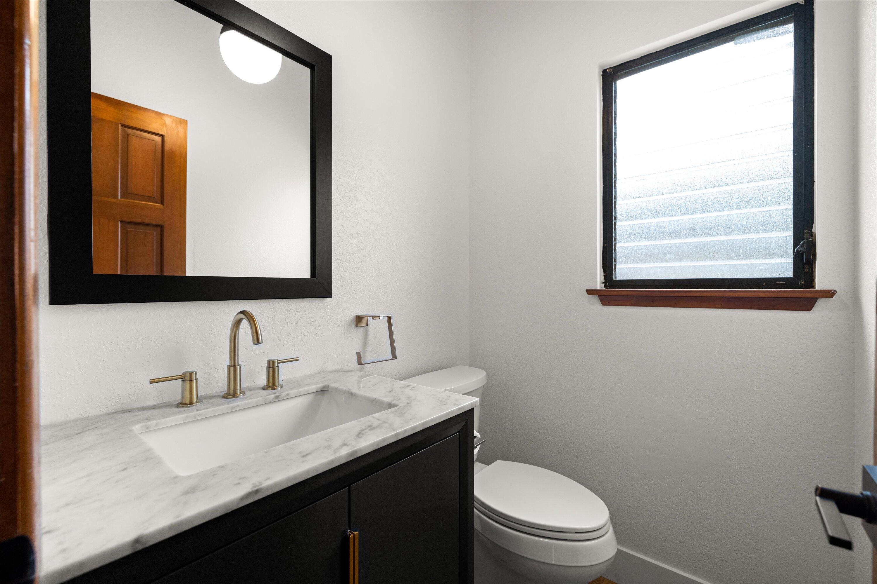 34 Rubio Road Santa Barbara, CA 93103 - Photo 15 of 36 a bathroom with a granite countertop sink toilet and mirror