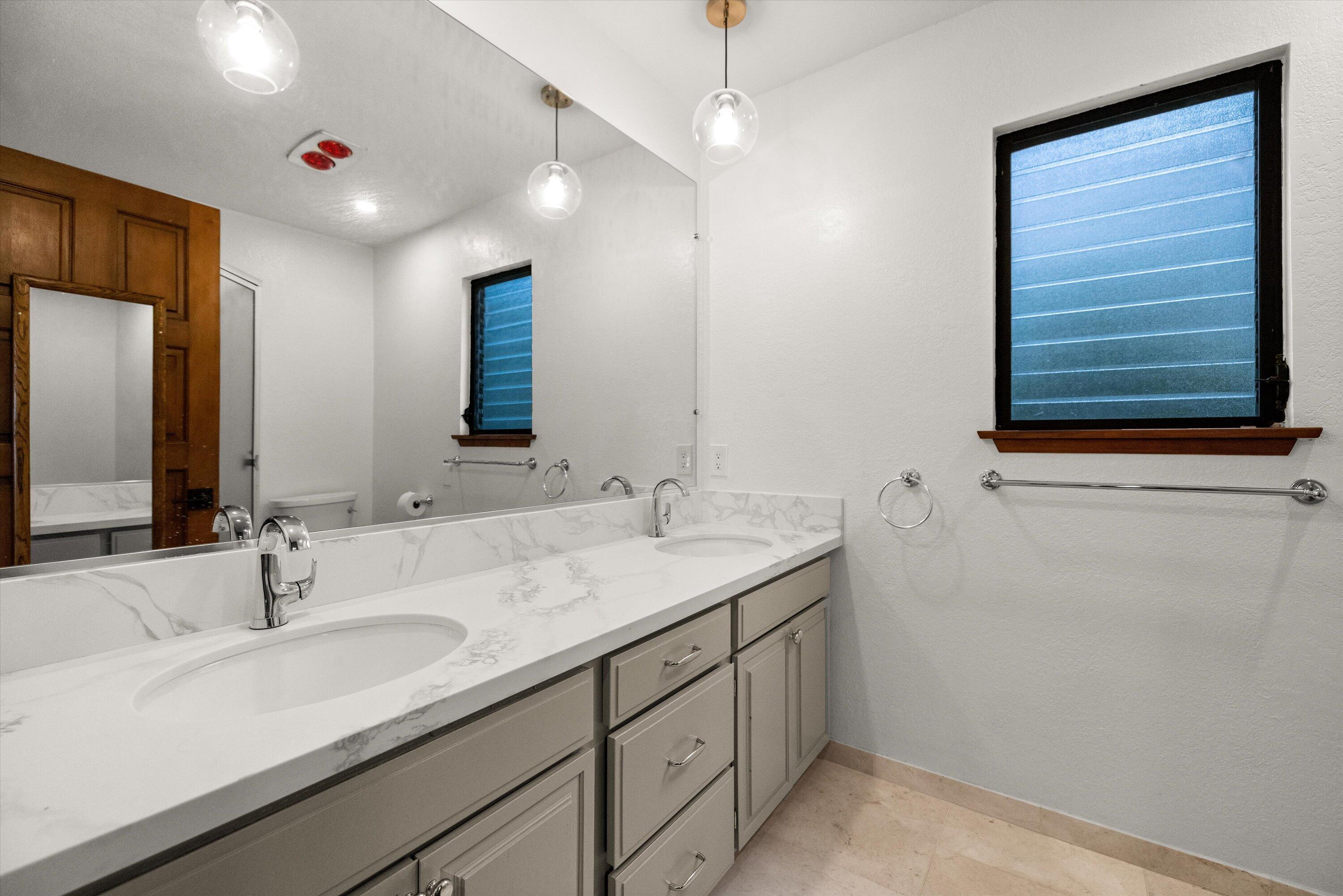 34 Rubio Road Santa Barbara, CA 93103 - Photo 17 of 36 a bathroom with a double vanity sink and a mirror