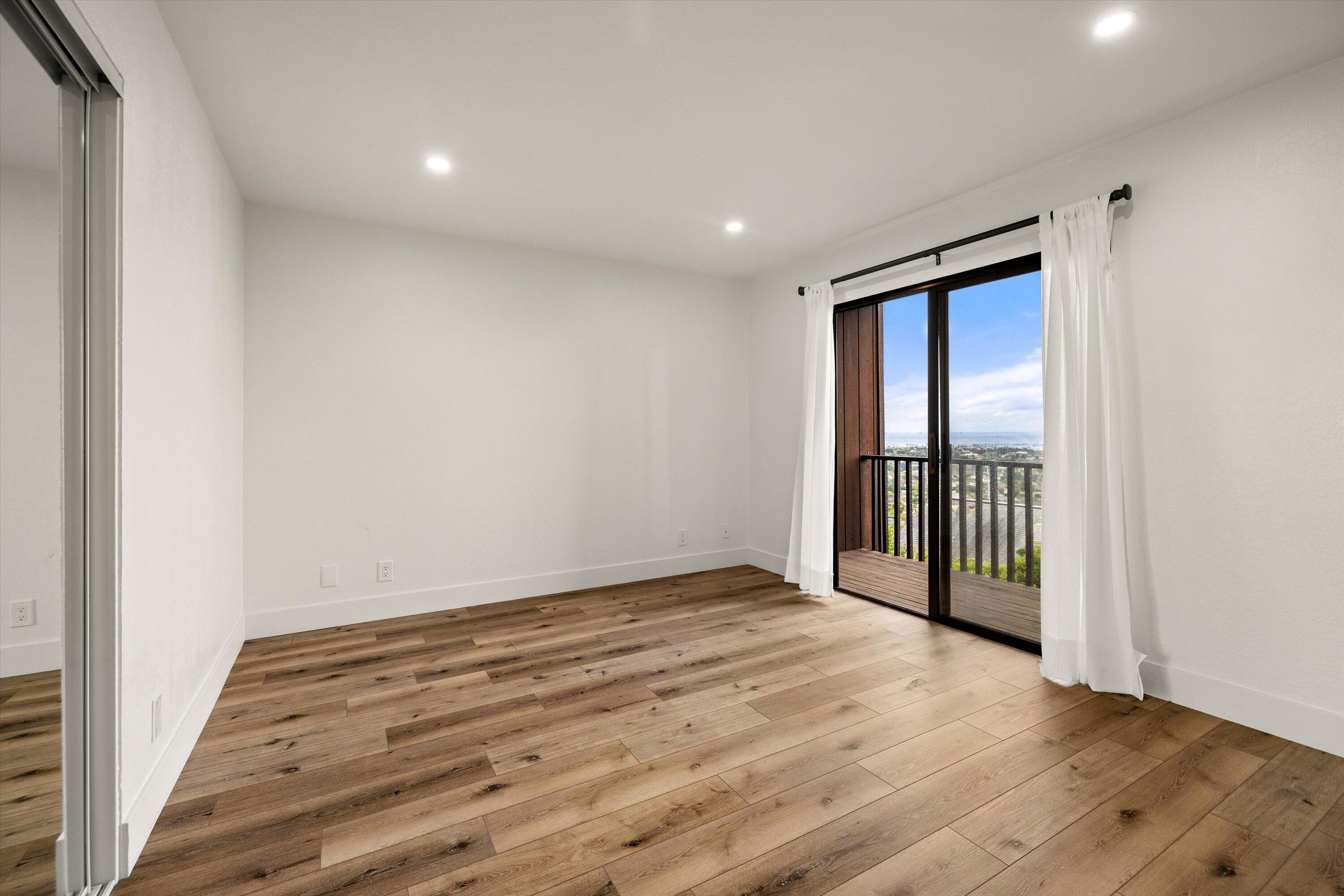 34 Rubio Road Santa Barbara, CA 93103 - Photo 19 of 36 a view of an empty room with wooden floor and a window