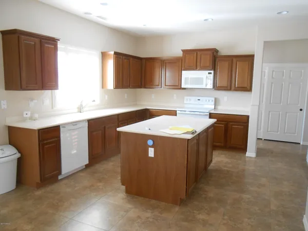 a utility room with a sink a stove and a microwave