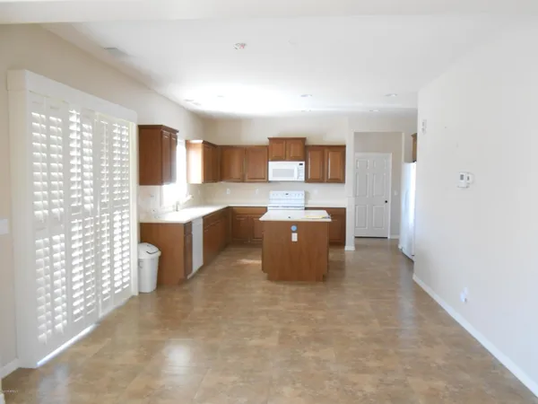 a kitchen with kitchen island cabinets and oven