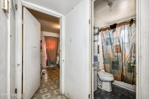 a bathroom with a toilet and a shower
