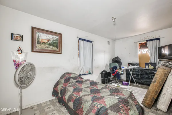a bedroom with bed and a chandelier