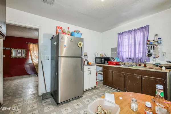 a kitchen with a refrigerator and a sink