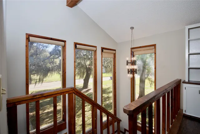 a view of staircase with furniture and windows