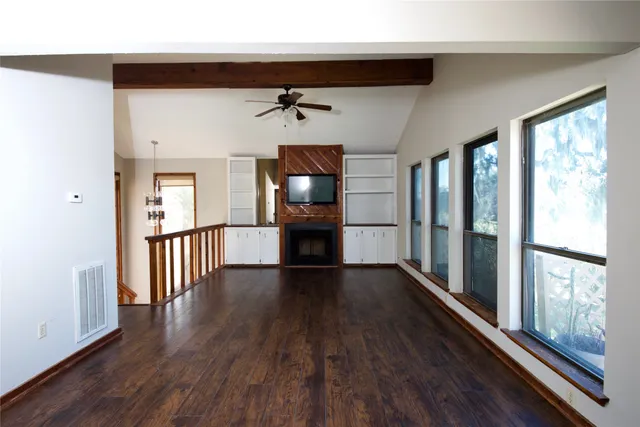 a view of a hallway view with wooden floor and staircase