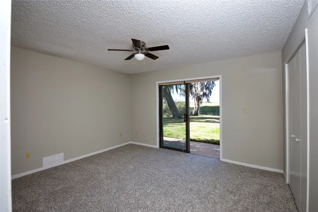 a view of room with a ceiling fan and window