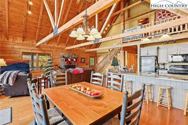 a bedroom with a bed a mirror and a lamp on the dresser