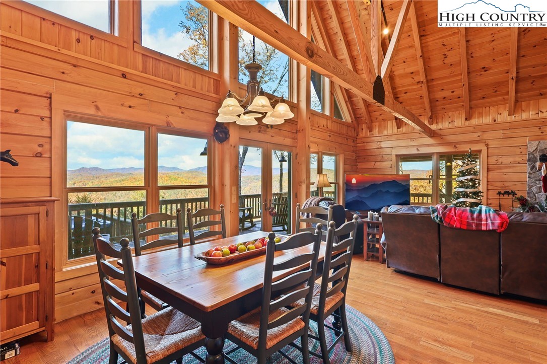 305 Fox Cove Road Ferguson, NC 28624 - Photo 12 of 50 a view of a patio with a dining table and chairs with wooden floor
