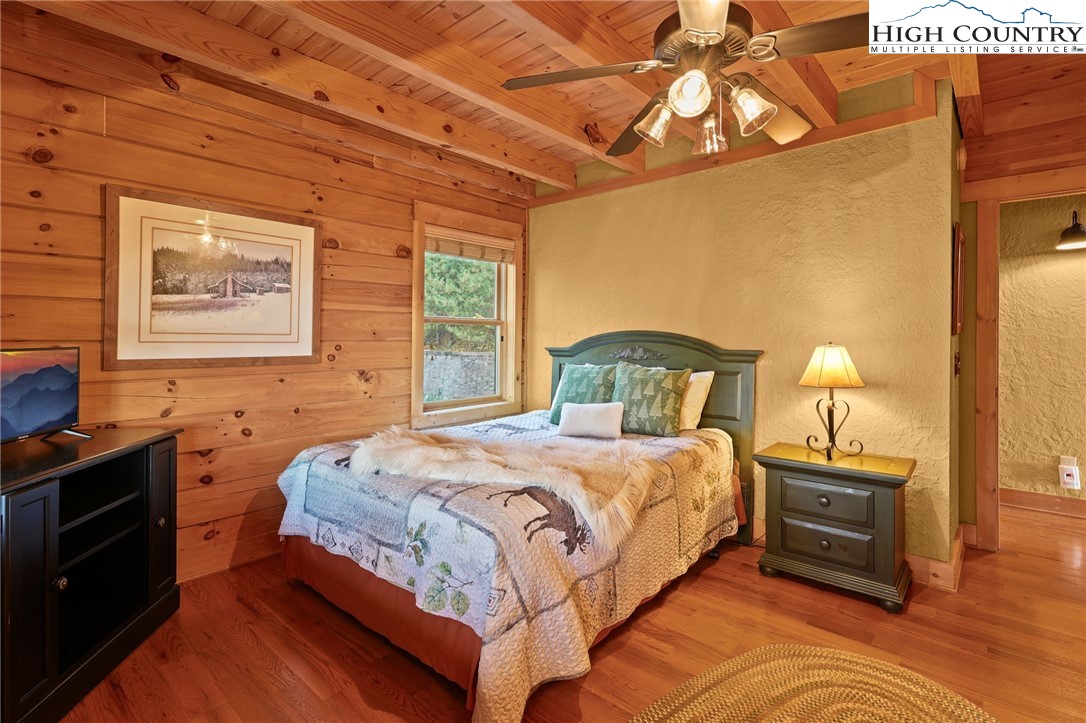 305 Fox Cove Road Ferguson, NC 28624 - Photo 23 of 50 a bedroom with a bed and a lamp on the dresser