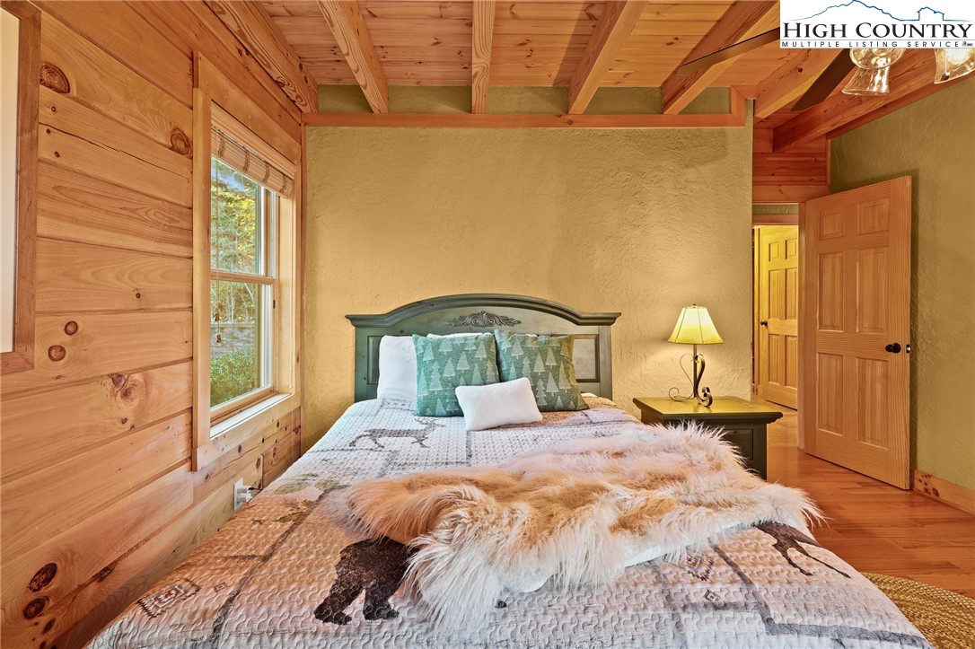 305 Fox Cove Road Ferguson, NC 28624 - Photo 25 of 50 a bedroom with a bed and wooden floor