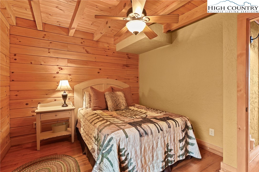 305 Fox Cove Road Ferguson, NC 28624 - Photo 28 of 50 a bedroom with a bed and a wall painting