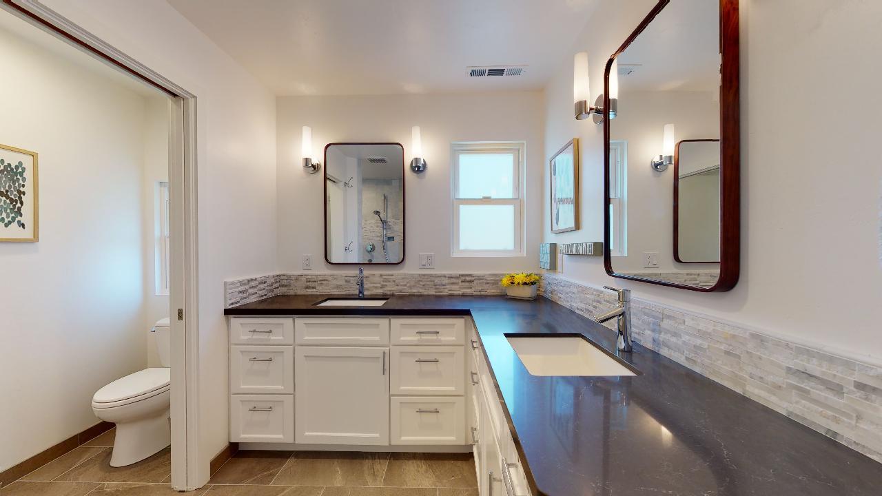 150 Vía Soderini Aptos, CA 95003 - Photo 28 of 73 a bathroom with a granite countertop sink and a mirror