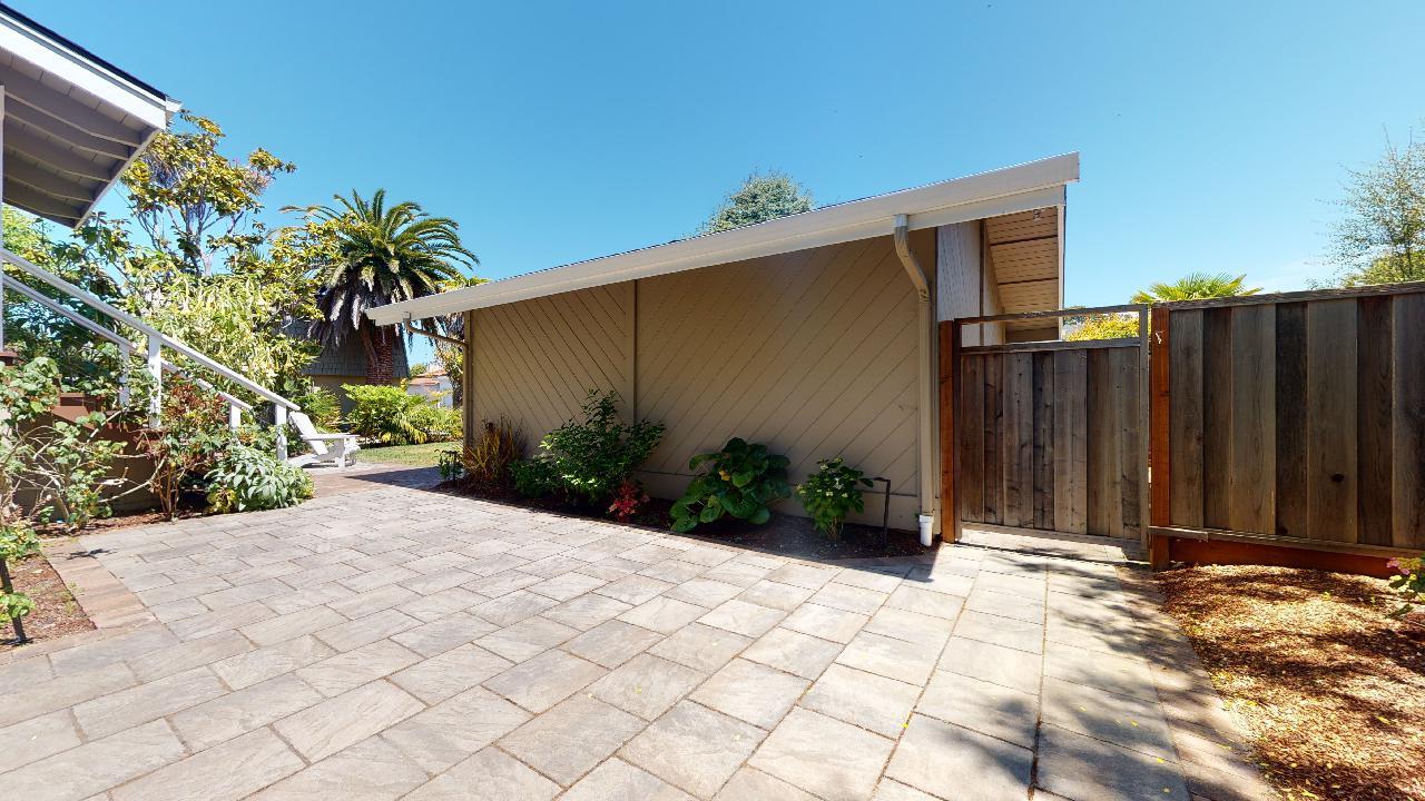 150 Vía Soderini Aptos, CA 95003 - Photo 53 of 73 a backyard of a house with potted plants and covered with wooden fence